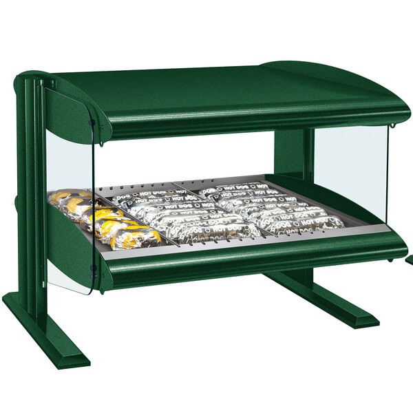 A green Hatco countertop food warmer with a glass shelf holding food.