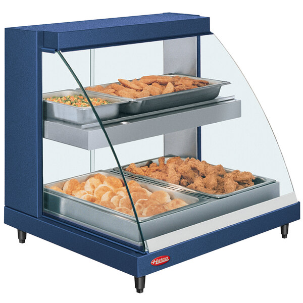 A blue Hatco countertop food warmer display with trays of food.