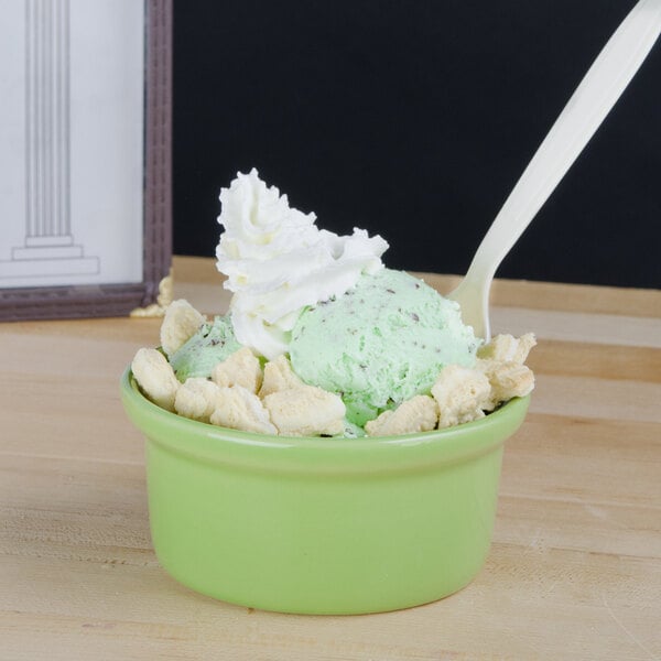A green bowl of ice cream topped with Dutch Treat Chopped Vanilla Cookies and Creme.