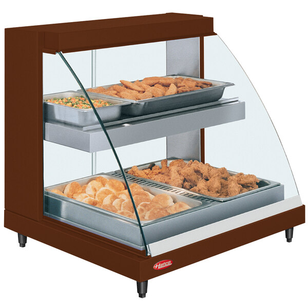 A Hatco countertop display case with food on two shelves.