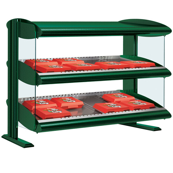 A Hunter Green Hatco horizontal shelf merchandiser with orange trays in a bakery display.