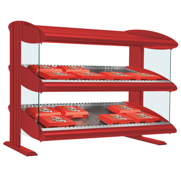 A red Hatco countertop double shelf hot food display case with trays of food inside.
