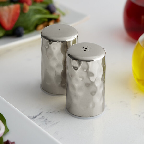 A set of American Metalcraft stainless steel salt and pepper shakers on a table.