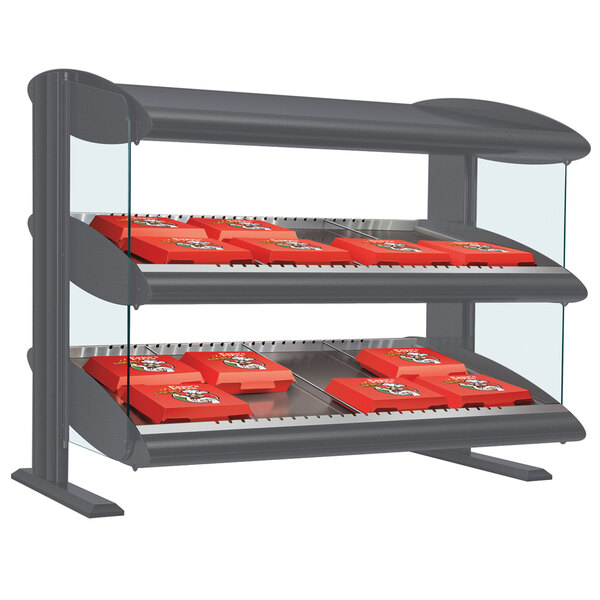 A Hatco countertop display case with a slanted shelf holding red boxes.