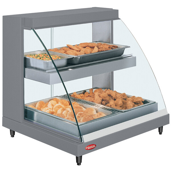 A Hatco Glo-Ray double shelf countertop hot food display case with food in it.
