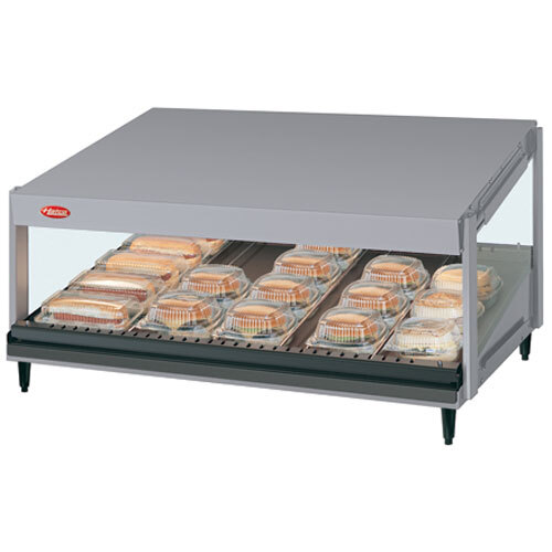 A Hatco Navy Blue Glo-Ray countertop food warmer with a slanted shelf of food.