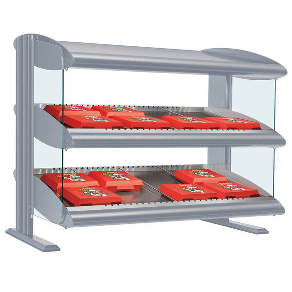 A white granite countertop food display with a slanted shelf holding red food containers.