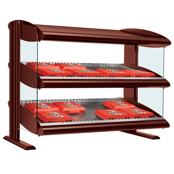 A Hatco countertop slanted single shelf display case with red boxes inside.