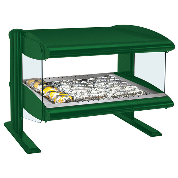 A Hatco Hunter Green countertop food warmer with a glass top on a table with food.