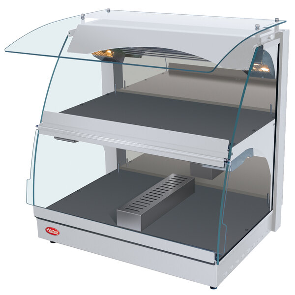 A white Hatco countertop food warmer with glass shelves and a curved glass top.