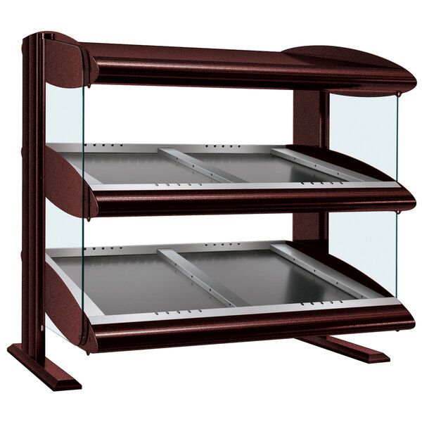 A close-up of a Hatco slanted double shelf heated zone display case on a counter with a glass shelf.