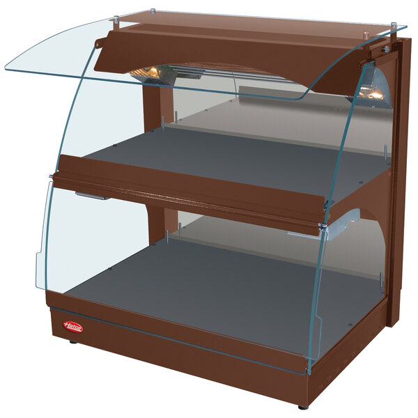 A brown Hatco curved merchandising warmer with glass shelves.