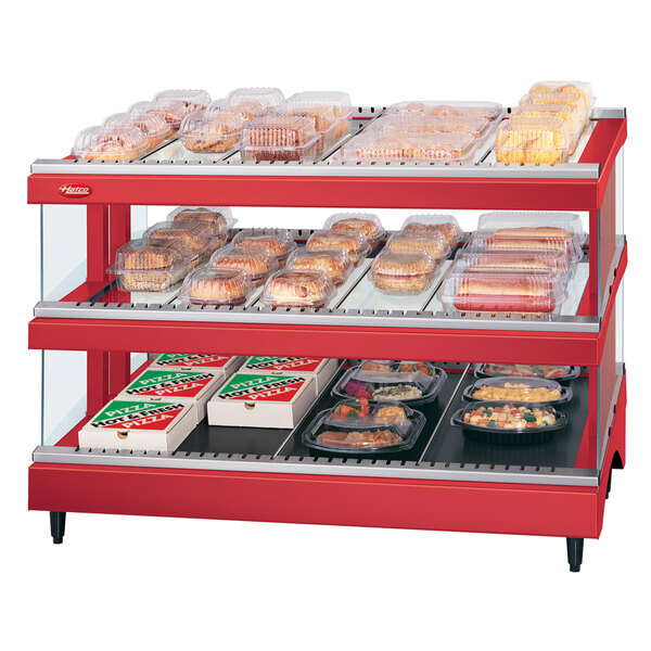 A red Hatco countertop display warmer with food on it.