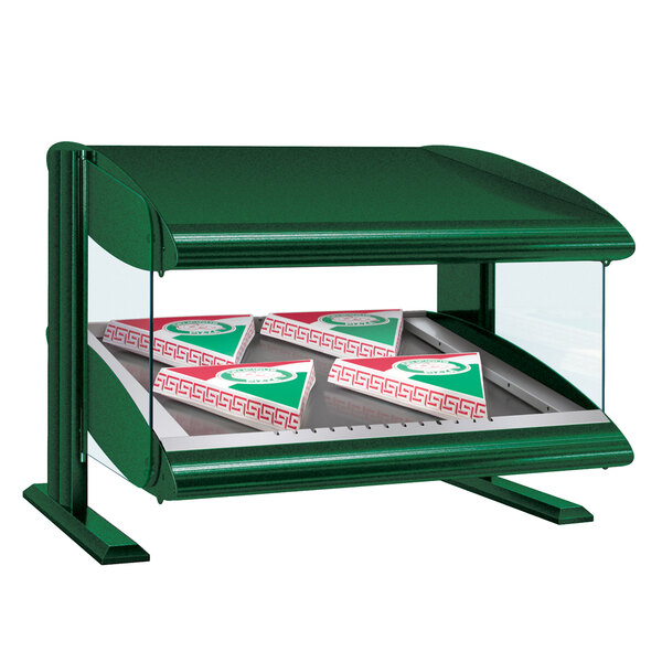 A green Hatco countertop heated food display case with pizza boxes inside.