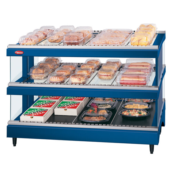 A navy blue Hatco food display case with heated shelves holding trays of food.