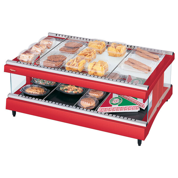A Hatco red heated glass display case on a counter with food inside.