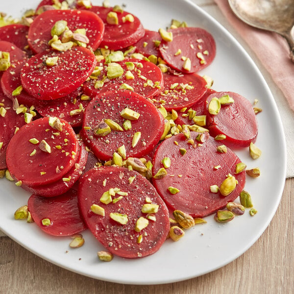 A plate of Hanover sliced red beets with pistachios.