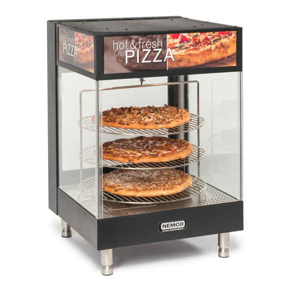 A Nemco countertop pizza merchandiser with three pizzas inside.