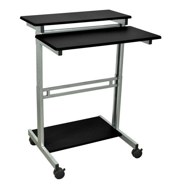 A black and silver Luxor stand up workstation with wheels.