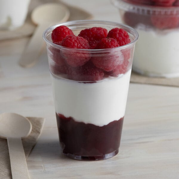 A Solo Ultra Clear plastic cup filled with yogurt and raspberries.