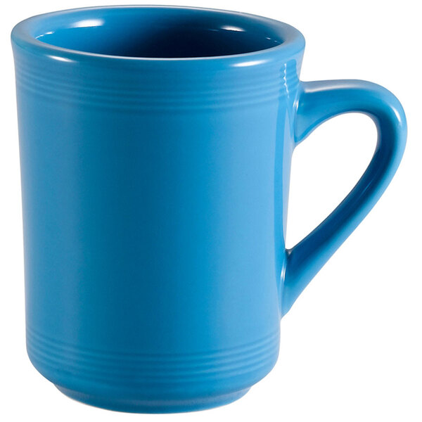 A close-up of the handle of a blue CAC Tango mug.