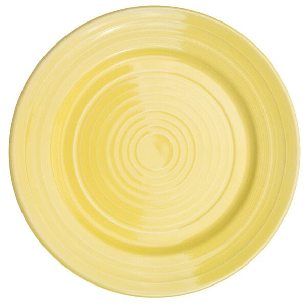 A yellow porcelain plate with a sunflower design in the center.