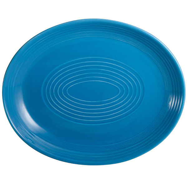 A peacock blue CAC China oval platter with a white spiral design.