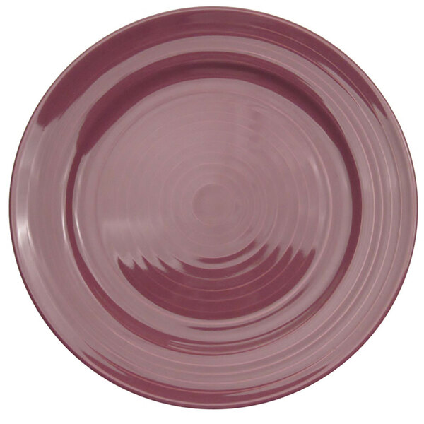 A close-up of a CAC Tango plum porcelain plate with a spiral pattern.