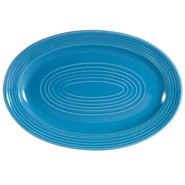 A blue oval platter with a white oval pattern and white circles.
