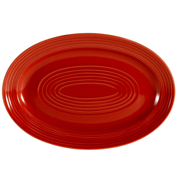 A red oval CAC China plate with a pattern.