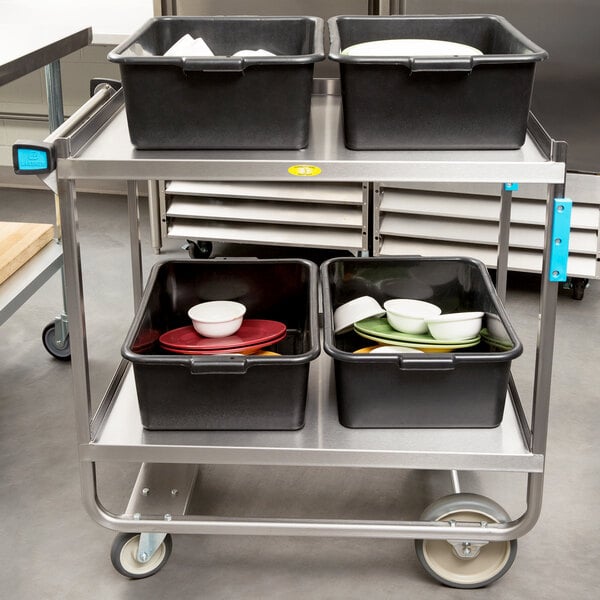 A Lakeside stainless steel utility cart with black bins full of dishes.