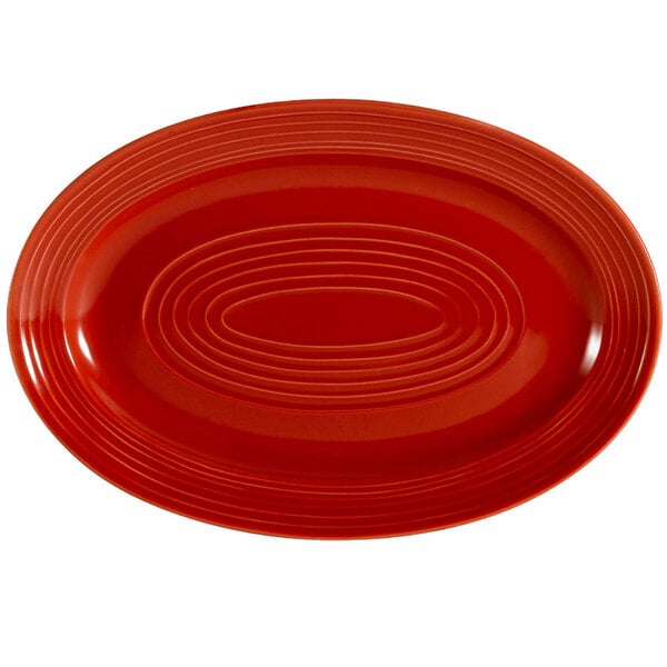 A red oval CAC China platter with an oval pattern.