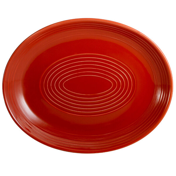 A red oval CAC China platter with a patterned rim.