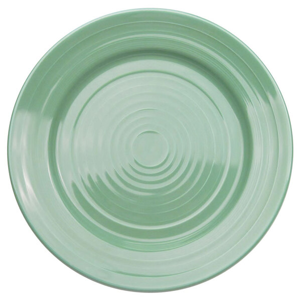 A close-up of a green CAC Tango 6 1/2" round plate with a spiral pattern in the middle.