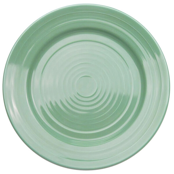 A close-up of a green CAC Tango round plate with a spiral pattern.