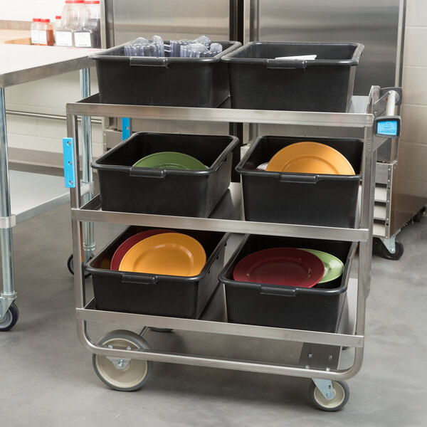 A Lakeside stainless steel utility cart with black containers and plates on shelves.
