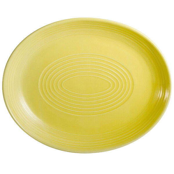 A yellow oval platter with a sunflower pattern in white.