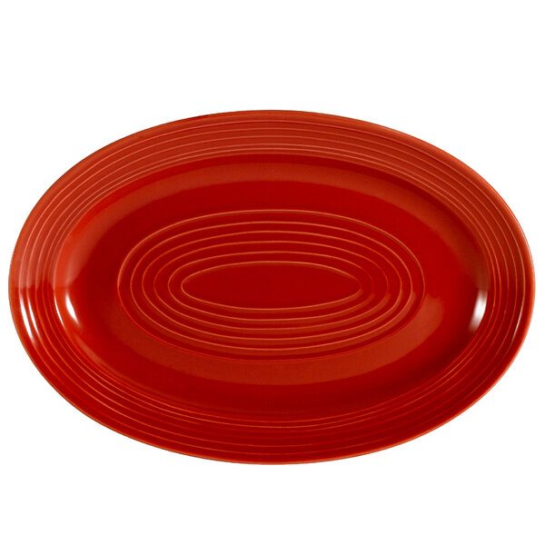 A red oval CAC China platter with a pattern.