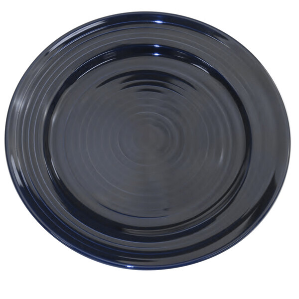 A cobalt blue porcelain plate with a rim and circle in the middle.