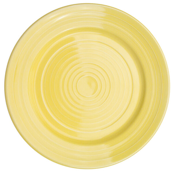 A yellow porcelain plate with a sunflower pattern on it.