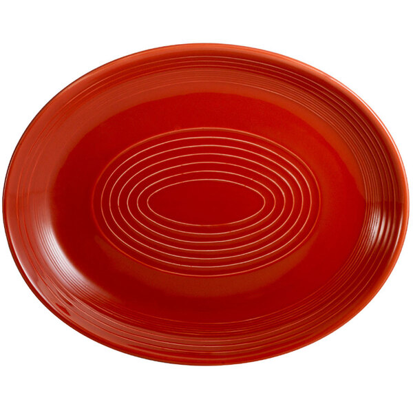 A red oval CAC China platter with a pattern of white lines.