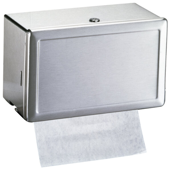 A stainless steel Bobrick surface-mounted paper towel dispenser.