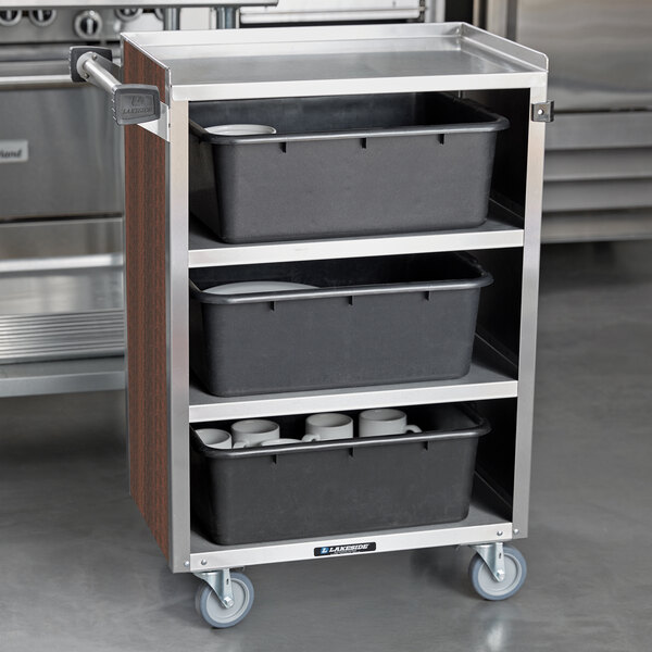 A Lakeside stainless steel utility cart with black containers on shelves.