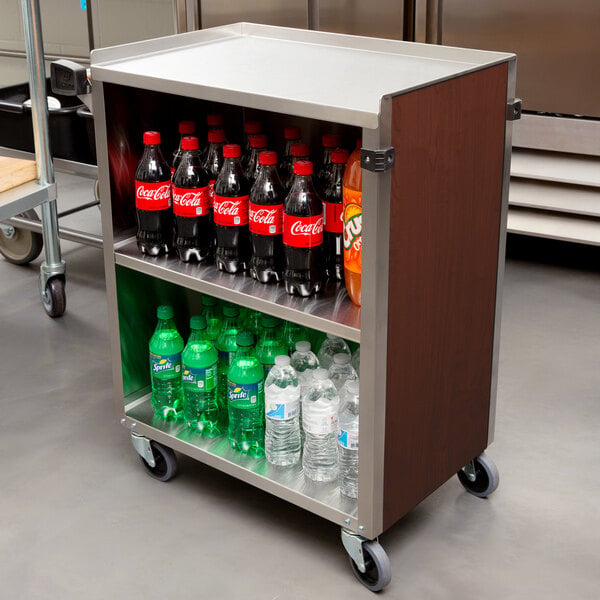 A Lakeside metal utility cart with soda and water bottles on it.