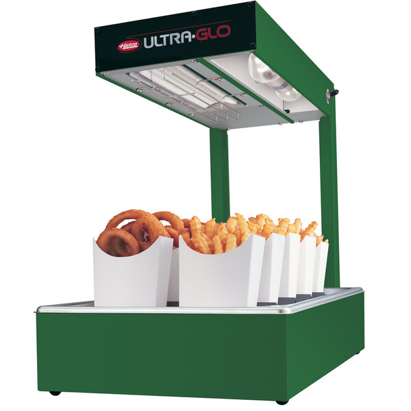 A green Hatco Ultra-Glo food warmer with fries and hot dogs inside.