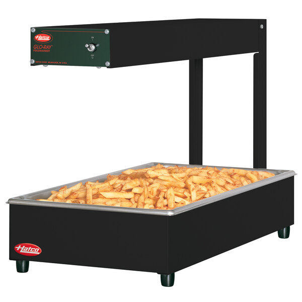 A Hatco Glo-Ray portable food warmer with food inside a large rectangular container.