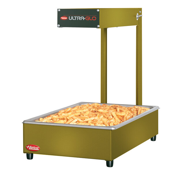 A large rectangular Hatco food warmer with french fries inside.