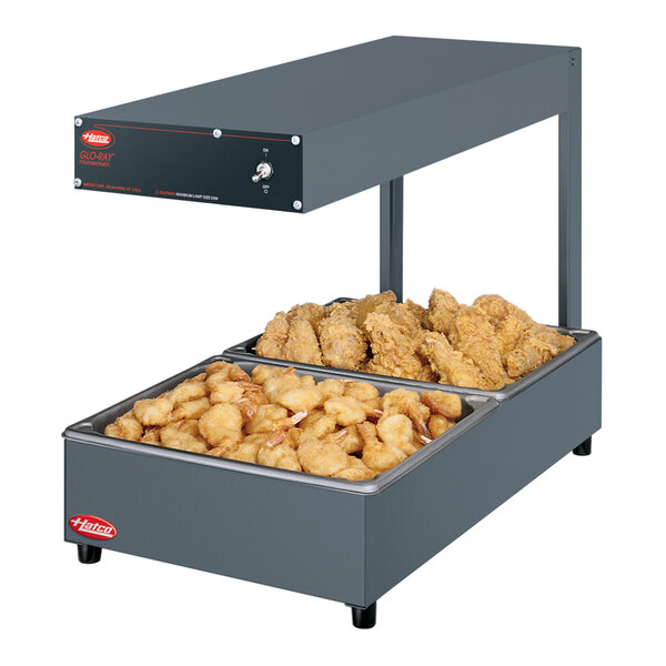 A Hatco Glo-Ray portable food warmer with two large trays of food.