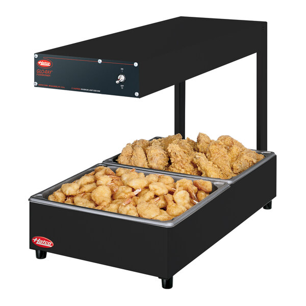 A Hatco portable food warmer with two large trays of food.