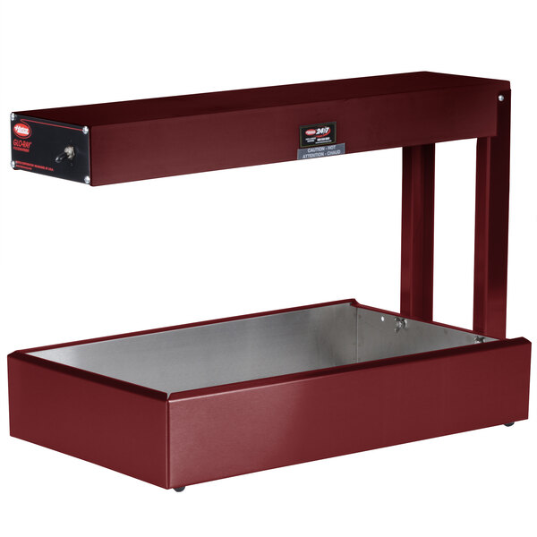 A red rectangular metal shelf with a metal lid on a counter.